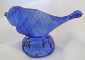 Blue glass bird with ashes in base